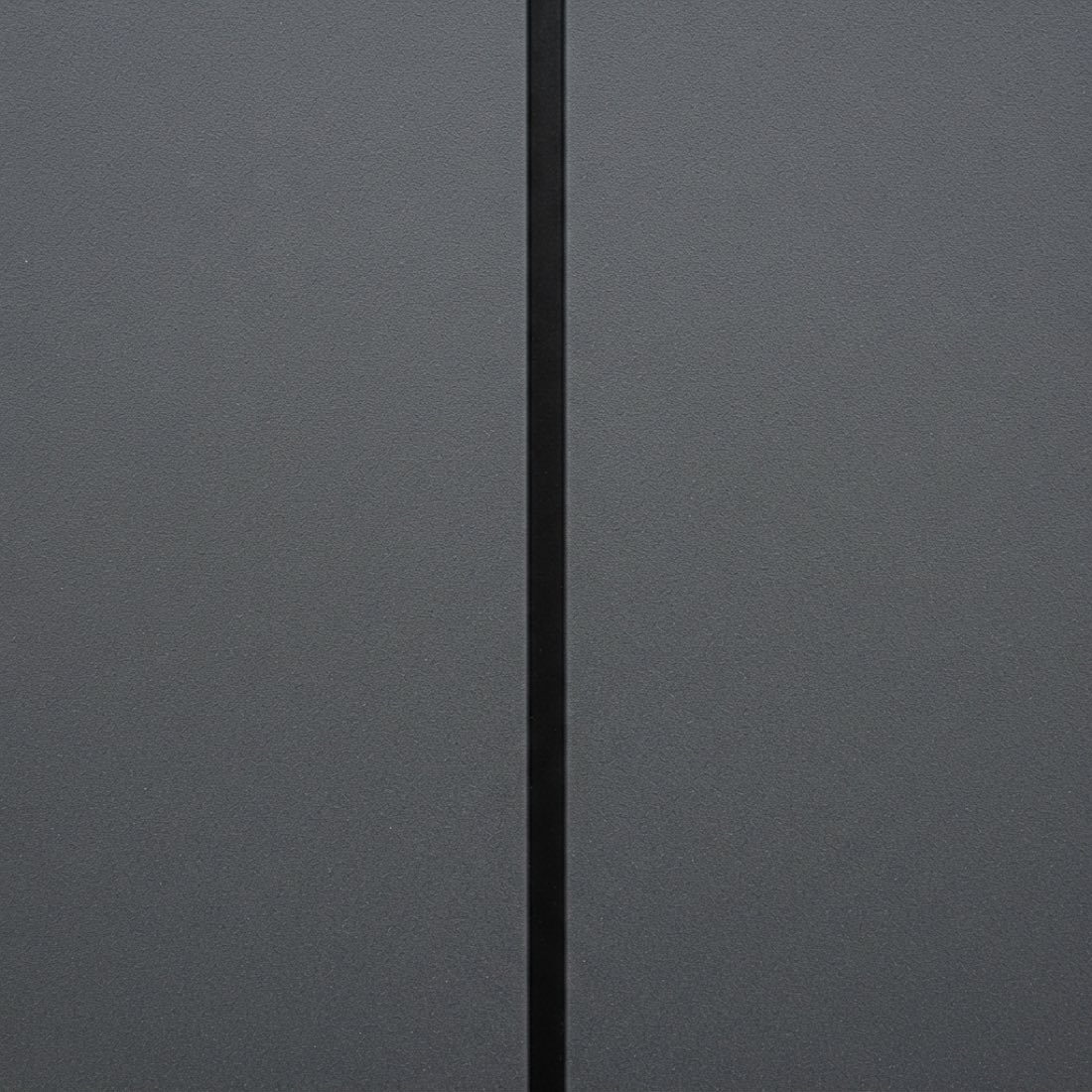 Dark grey composite cladding board in close detail, flat and matte with a crisp joint line.